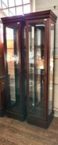 A pair of tall narrow display cabinets 192cm x 40cm x 38cm each