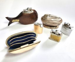Five vintage cigarette lighters, together with an oyster shell purse