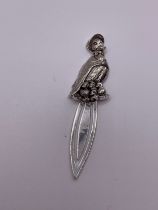 A novelty silver bookmark, designed with a puddle duck wearing a bonnet and cape, with four