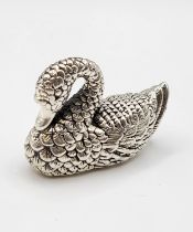 A novelty silver figure of a swan, with textured feather details, marked 925, 2.8 cm high.