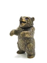 A novelty brass vesta case in the form of a grizzly bear, with red eyes, 6.5 cm high.