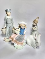 Lladro boy with pair of buckets, 22cm, girl holding kitten, 18cm, white rabbit, 12cm (small chip