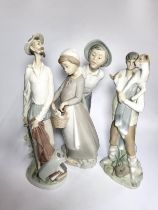 Lladro boy with goat, 27cm, man with sword, 30cm, and boy and girl group, 29cm. (3)