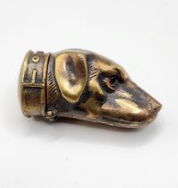 A novelty brass vesta case in the form of a dog's head.