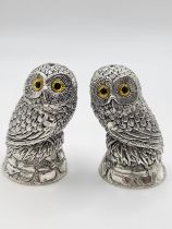 A pair of novelty silver owl condiments, the seated owls on naturalistic perches, 5 cm high.