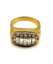 A gentleman's yellow metal and diamond dress ring, set to the centre with five graduated emerald-cut