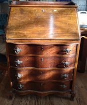 A 20th century mahogany serpentine front bureau. 106cm x 75cm x 50cm.