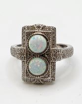A silver, cubic zirconia, and opalite panel ring, in the Art Deco style, set with two round cabochon