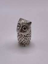 A novelty silver pin cushion in the form of a seated owl, 3.5 cm high.