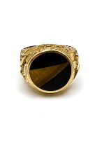 A yellow gold, tigers eye and onyx ring, set with three angular segments of onyx and tigers eye, the