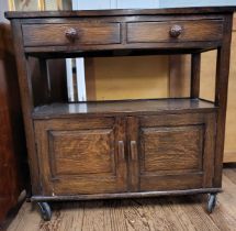 A cabinet on casters. Two drawers and two doors. 83cm x 84cm x 37cm.