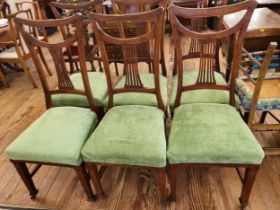 Six dining chairs with green upholstered seats