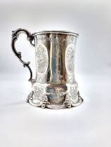 A silver Christening mug, hallmarked London 1857 (indistinct makers mark, A.M) the panelled sides