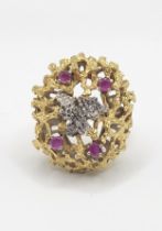 An unusual mid to late 20th century yellow gold, diamond, and ruby cocktail ring, the textured