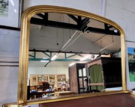 A gilt framed over-mantle mirror. 81cm x 124cm.