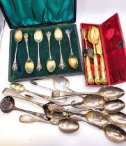 A set of six silver spoons, cased, together with a silver gilt knife, fork and spoon, cased, six