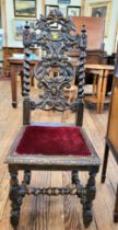 A hall chair, ornately decorated back with barley twist supports and foliate decoration, with