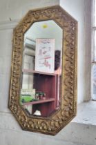 A long wall mirror in octagonal brass frame. 74cm x 43cm.