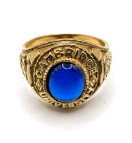 A 9ct yellow gold and blue stone Cambridge University college ring, set with a blue glass