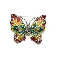 A silver and plique-a-jour enamel style butterfly brooch, set with red, yellow, and green glass,