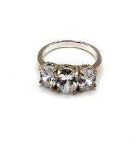 A silver and cubic zirconia ring, set with three oval-cut cubic zirconias, size R 1/2.