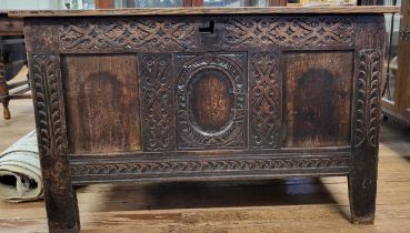 An oak chest with hinged lid. 68cm x 110cm x 54cm.