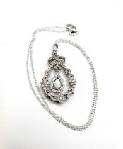 A silver, opal, and cubic zirconia wreath drop pendant, set with a pear-shaped cabochon opal