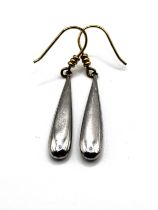 A pair of silver drop earrings, the smooth tapered drops suspended from silver gilt hooks, unmarked,