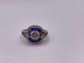 A blue and white cubic zirconia cocktail ring, in the Art Deco style, with collet-set round-cut