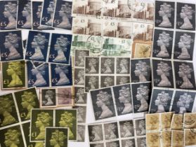 A collection of UK stamps including eleven £5 Queen's head, twelve £1.50 Queen's head, eight £1.00