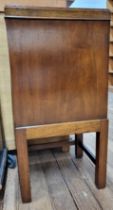 A chamber pot cabinet, with slatted door, raised on four legs and stretcher. 72cm x 35cm x 33cm.