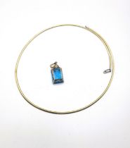 A yellow gold, diamond, and blue topaz necklace, set with a rectangular cut topaz, measuring