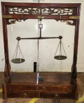 A set of Chinese apothecary weighing scales, the hardwood stand with brass weighing scales. 95cm x