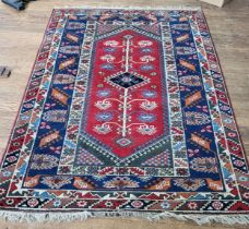 A red and blue rug. 257cm x 149cm.
