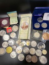 A group of various coinage including European examples contained in plastic albums, together with