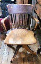 A swivel captain's chair with spindle back