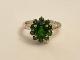 A 9ct yellow gold and Russian chrome diopside cluster ring, set with a mixed oval-cut and round-