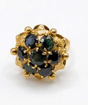 An Italian 18ct yellow gold and sapphire ring, of floral cluster design, set with seven dark blue