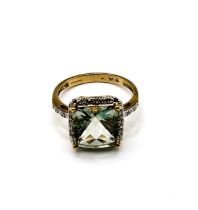 A 9ct yellow gold and prasiolite ring, set with a chequerboard faceted green quartz, surrounded with