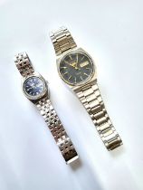 A ladies and gentleman's Seiko '5' Automatic day/date watches on articulated bracelets.