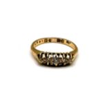 A late Victorian 18ct yellow gold and diamond ring, set with five old-cut diamonds, the largest