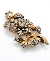 A mid 20th century vintage gold and diamond brooch, of foliate design, centred with a round-cut