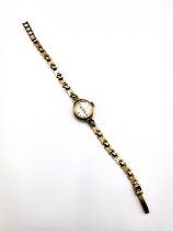 A 9ct yellow gold ladies Rotary wristwatch, with round baton dial, on fancy-link 9ct yellow gold