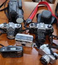 Assorted cameras: two Pentax film SLRs, an Olympus digital camera, a Kodak Instamatic 100, a Samsung