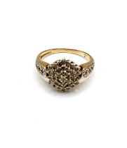 A 9ct yellow gold and diamond cluster ring, set with round-cut diamonds, in a hexagonal cluster