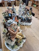 A group of Capo di Monte bisque figures of gentlemen seated, one as a cobbler, and a G Armani figure