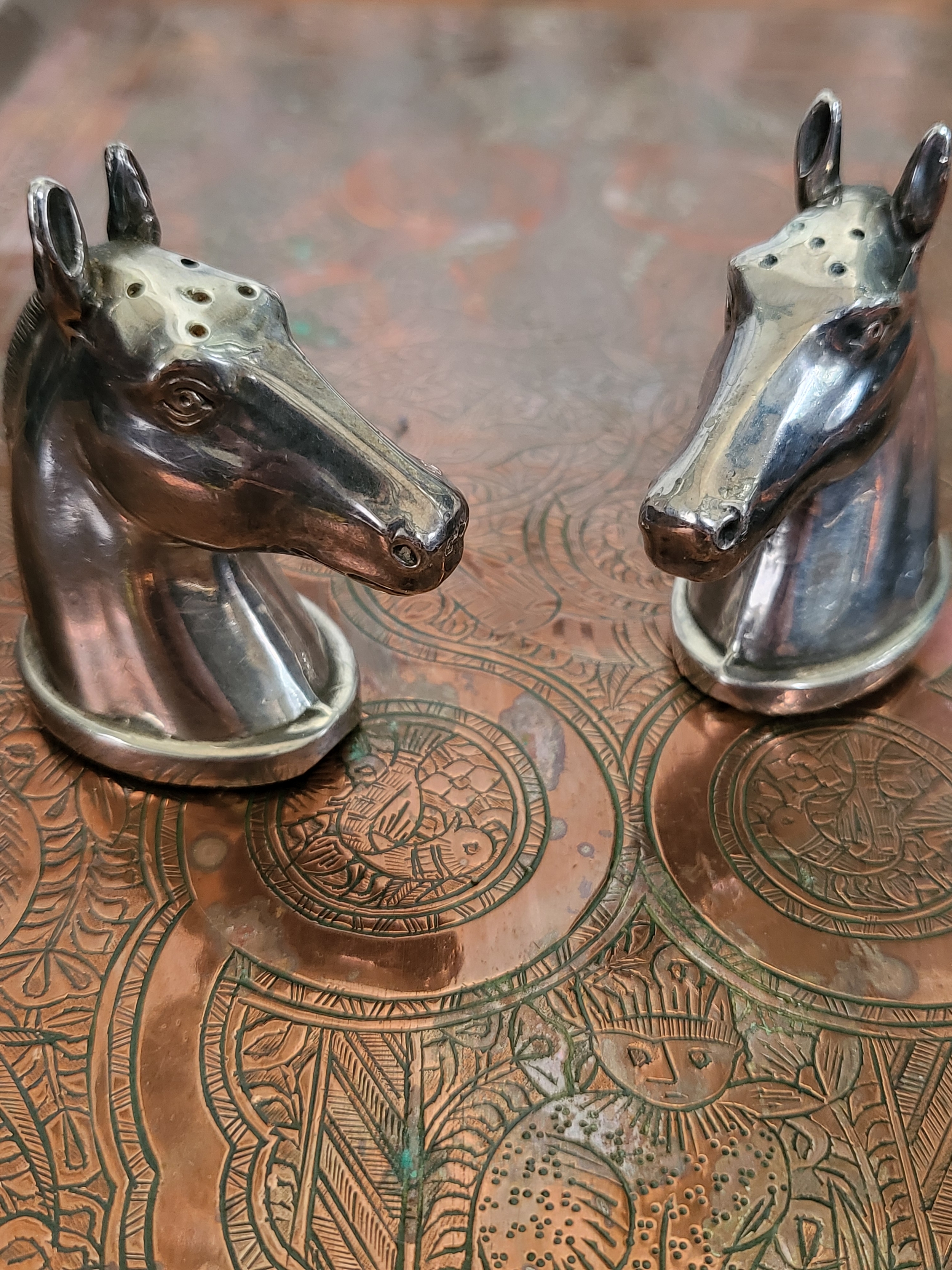 A heavy inscribed copper tray, a bone handled cut-throat razor in a leather pouch, and a cruet set