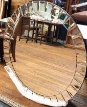 A large circular mirror with bevelled rectangular details around the circumference. 110cm diameter