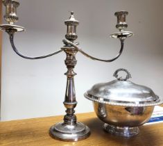 A silver-plate tureen with gadrooned rim and silver-plate candelabrum.