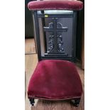 A prayer chair with burgundy velvet upholstery